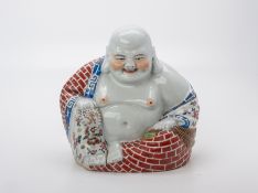 A FAMILLE ROSE PORCELAIN MODEL OF BUDAI