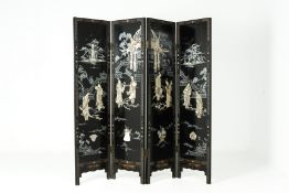 A CHINESE BLACK LACQUERED FOUR PANELLED SCREEN