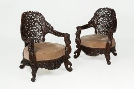 A PAIR OF INDIAN CARVED HARDWOOD ARMCHAIRS
