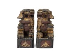 A PAIR OF CARVED WOOD FOO DOG FINIALS