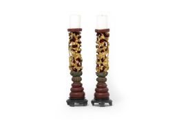 A PAIR OF CARVED AND GILT DRAGON CANDLESTICKS