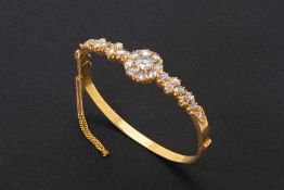 A GOLD AND ROSE CUT DIAMOND HINGED BANGLE