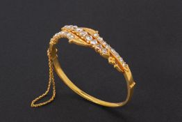 A GOLD AND ROSE CUT DIAMOND BANGLE