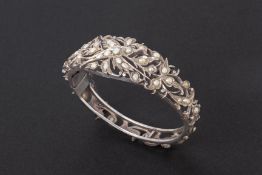 A PIERCED SILVER AND SEED PEARL BANGLE