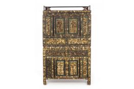 AN ELABORATE CARVED AND PARCEL-GILT CABINET