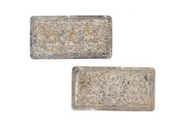 A PAIR OF REPOUSSE SILVER PILLOW ENDS