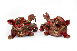 A PAIR OF LARGE LACQUERED AND PARCEL-GILT CARVED WOOD LIONS