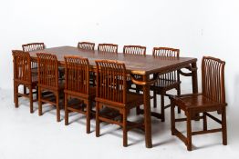 A LARGE ELM DINING TABLE AND TEN CHAIRS