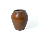 A LARGE BROWN GLAZED JAR