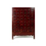 A CHINESE RED LACQUERED MEDICINE CABINET