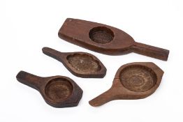 A GROUP OF FOUR WOODEN COOKING MOULDS