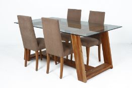 A GLASS TOPPED DINING TABLE AND FOUR CHAIRS