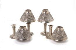 FOUR CAMBODIAN SILVER CANDLE HOLDERS AND COVERS