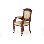 AN ANTIQUE OAK UPHOLSTERED OPEN ARMCHAIR