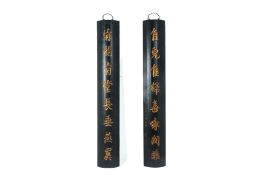 A PAIR OF BLACK LACQUERED CARVED BAMBOO WALL HANGINGS