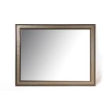 A LARGE FRAMED WALL MIRROR