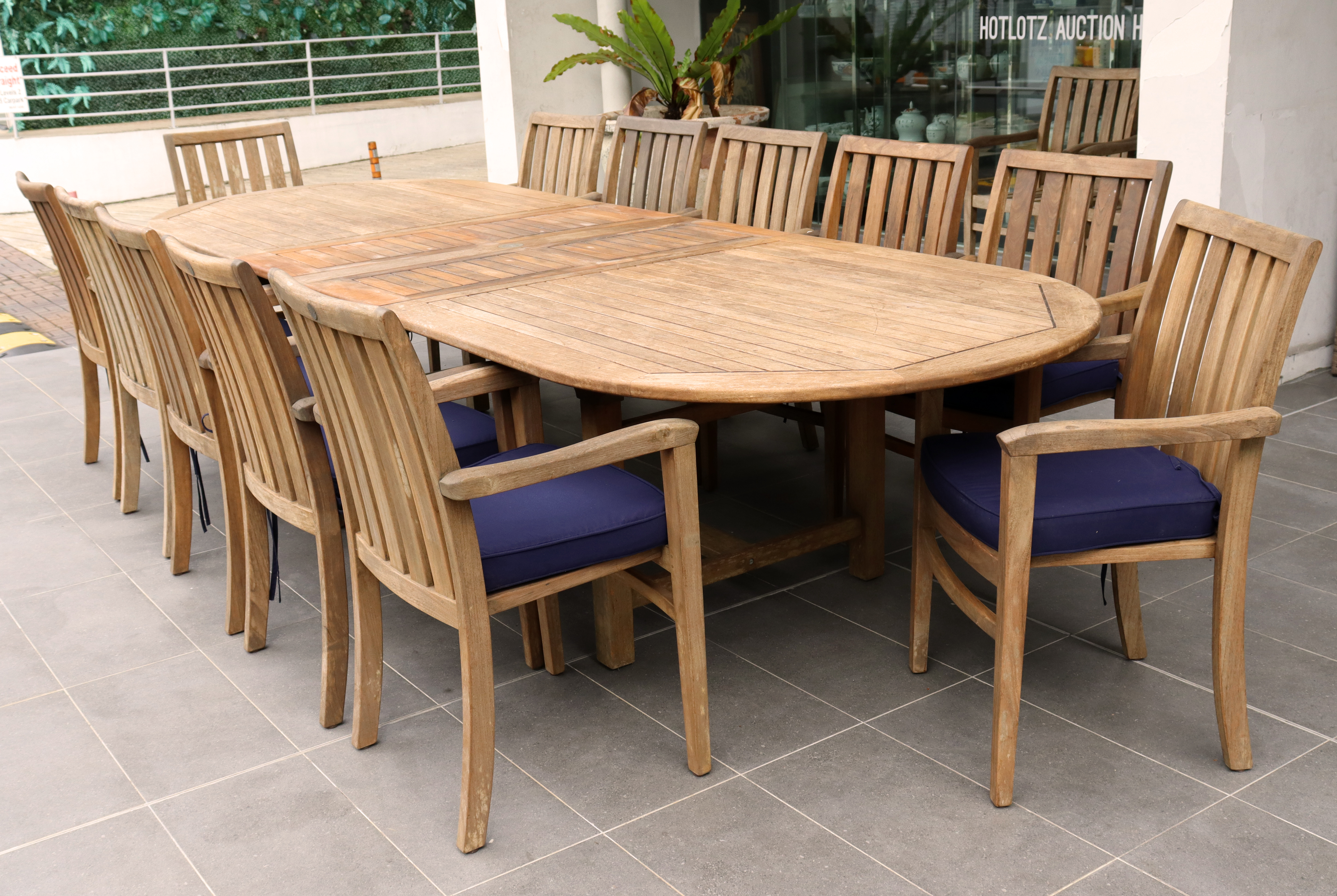 A LARGE TEAK OUTDOOR FURNITURE SET BY NAUTIQUE