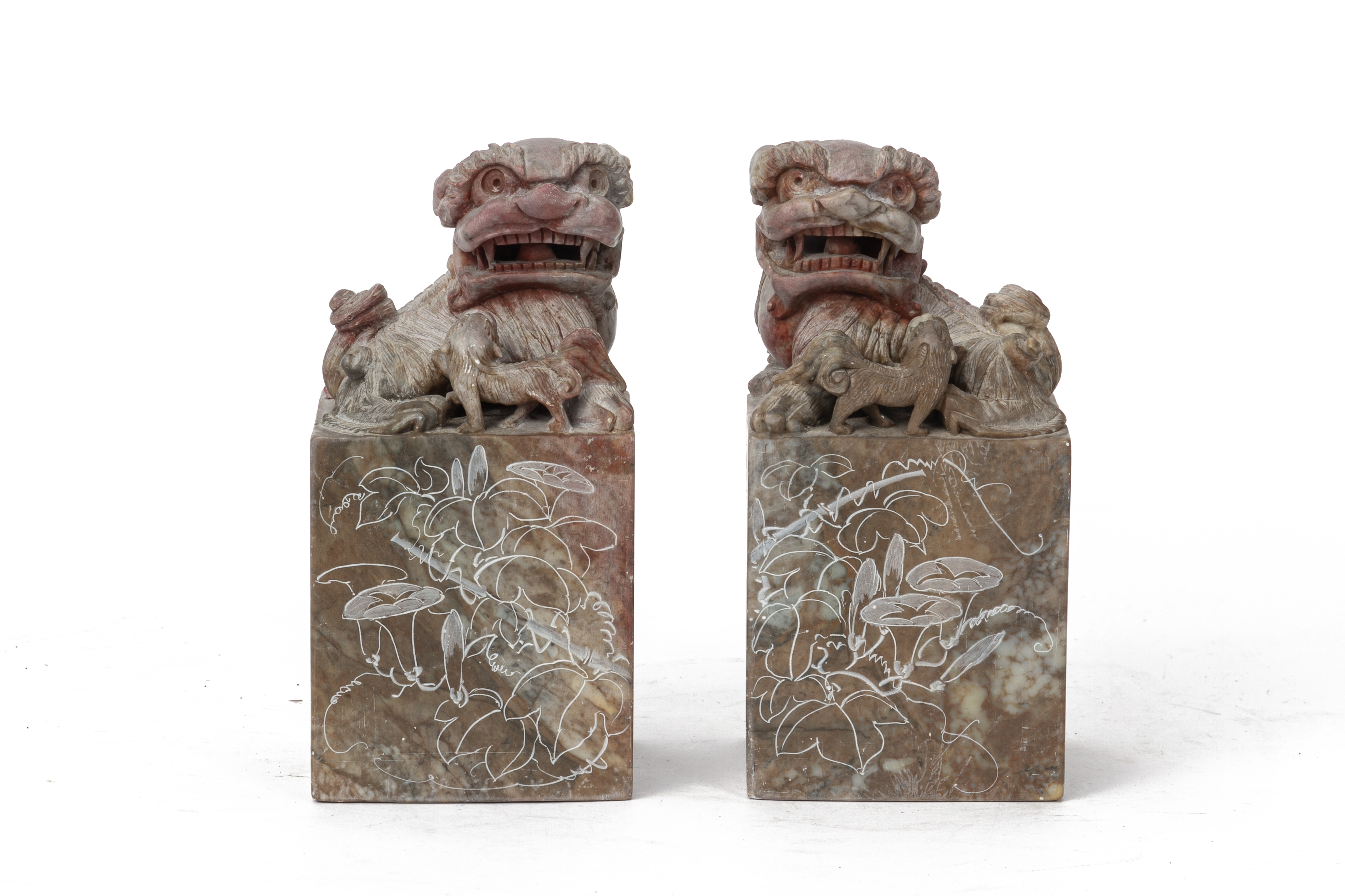 A PAIR OF CARVED SOAPSTONE BUDDHIST LIONS