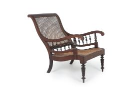 A WOODEN CANED ARMCHAIR