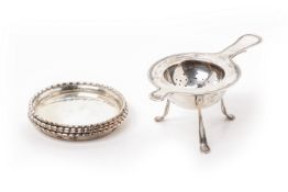 A SET OF FOUR DANISH SILVER COASTERS AND A TEA STRAINER