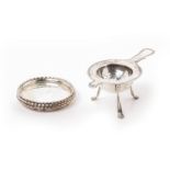 A SET OF FOUR DANISH SILVER COASTERS AND A TEA STRAINER