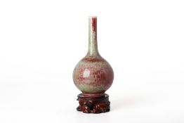 A PEACHBLOOM GLAZED PORCELAIN BOTTLE VASE