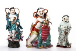 THREE FAMILLE ROSE PORCELAIN FIGURES OF LIU HAI