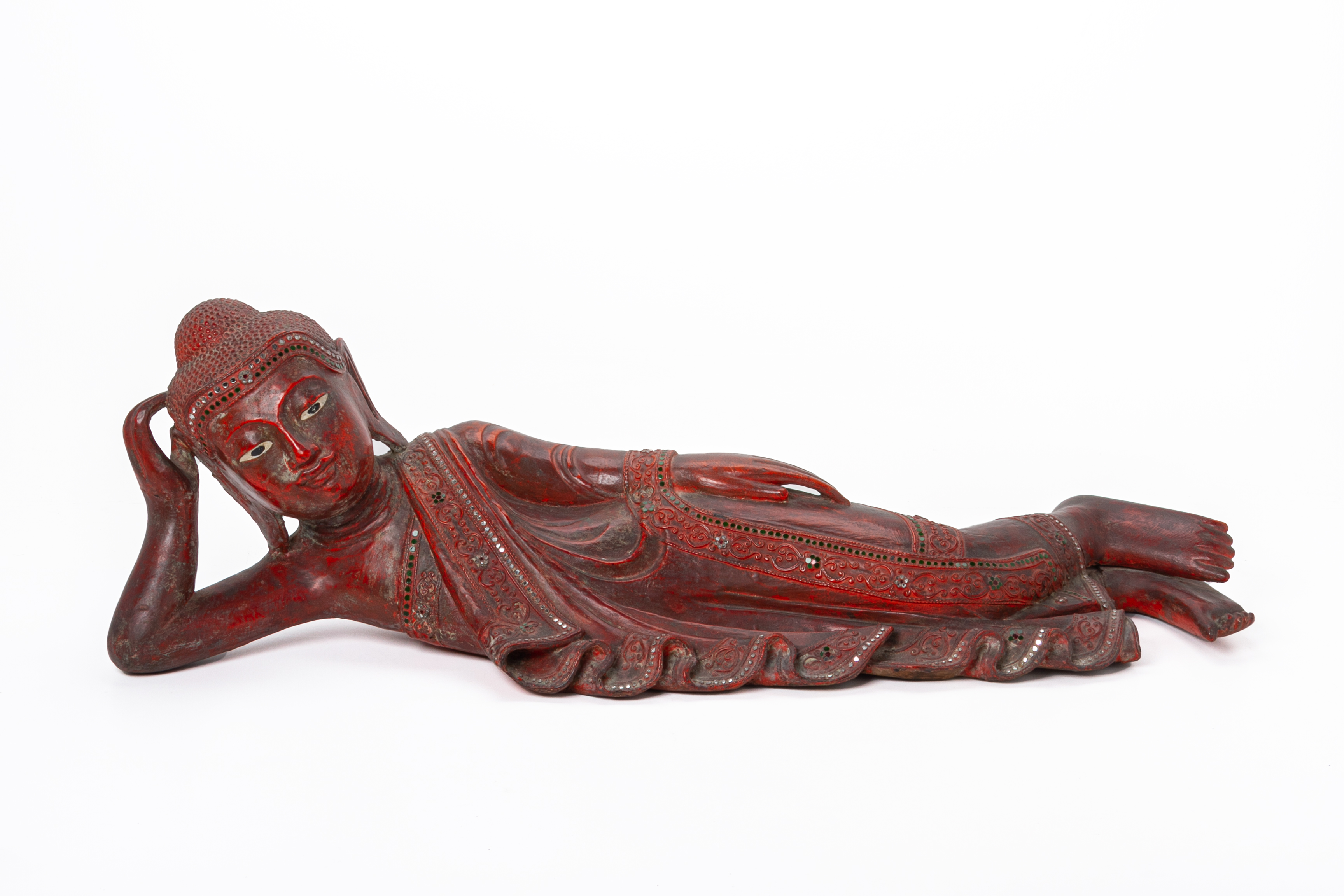 A BURMESE CARVED AND RED LACQUER RECUMBENT BUDDHA
