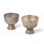 A PAIR OF REPOUSSE SILVER BOWLS ON STANDS