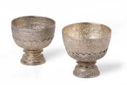 A PAIR OF REPOUSSE SILVER BOWLS ON STANDS
