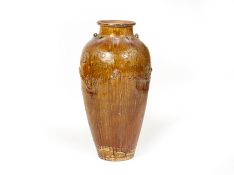 A LARGE BROWN GLAZED MARTABAN JAR