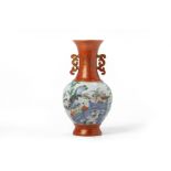 A CORAL GROUND FAMILLE ROSE TWIN HANDLED PORCELAIN VASE
