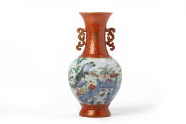 A CORAL GROUND FAMILLE ROSE TWIN HANDLED PORCELAIN VASE