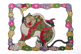 A CHINESE EMBROIDERED MYTHICAL BEAST APPLIQUE