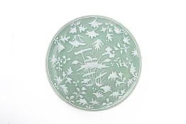 A SLIP DECORATED CELADON GROUND DISH