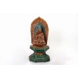 A CHINESE POTTERY FIGURE OF BUDDHA ON STAND