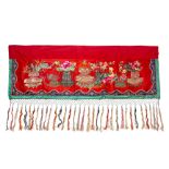 AN EMBROIDERED AND TASSELED RED SILK VALANCE