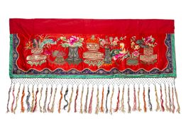 AN EMBROIDERED AND TASSELED RED SILK VALANCE