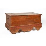 A VERY LARGE INDONESIAN TEAK WHEELED TRUNK