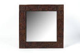 AN INDIAN CARVED WOOD MIRROR