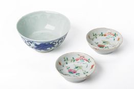A BLUE AND WHITE PORCELAIN BOWL AND TWO SAUCERS