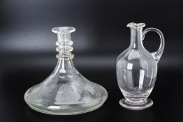 AN ENGRAVED GLASS SHIPS DECANTER AND A GLASS CLARET JUG