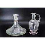 AN ENGRAVED GLASS SHIPS DECANTER AND A GLASS CLARET JUG