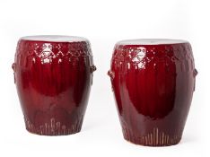 A PAIR OF RED GLAZED PORCELAIN STOOLS