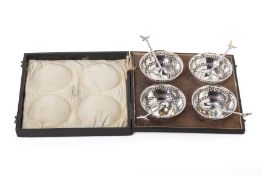 A SET OF FOUR SILVER BON BON DISHES AND FOUR SPOONS