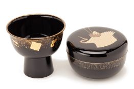 A BLACK LACQUER CIRCULAR BOX AND A FOOTED BOWL