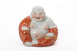 A PORCELAIN FIGURE OF A BUDDAI