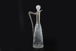 A SILVER MOUNTED CUT GLASS CLARET JUG