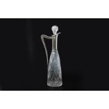 A SILVER MOUNTED CUT GLASS CLARET JUG