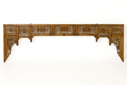 A CHINESE CARVED WOOD ARCHED PANEL